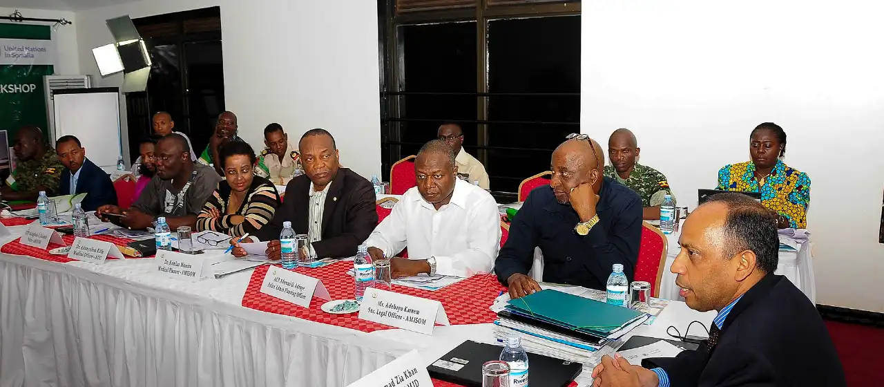 Officials from several institutions in a round-table workshop in Kampala.